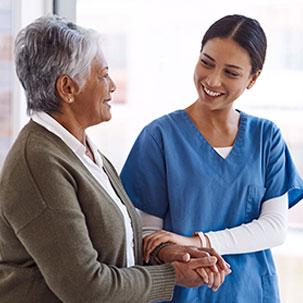 Nurse and patient sharing a warm, caring interaction.